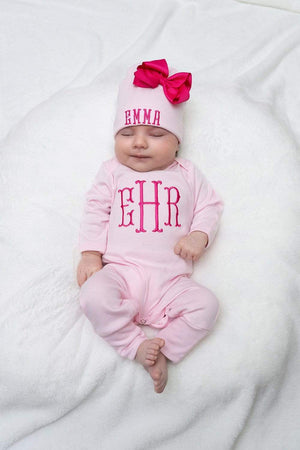 Newborn girl wearing a pink sleeper